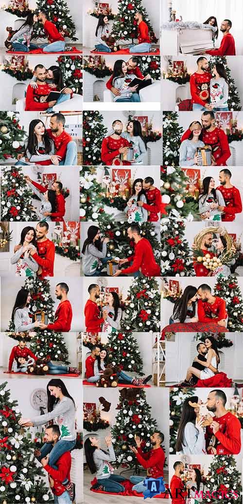     -  / Happy couple decorates christmas tree - Clipart