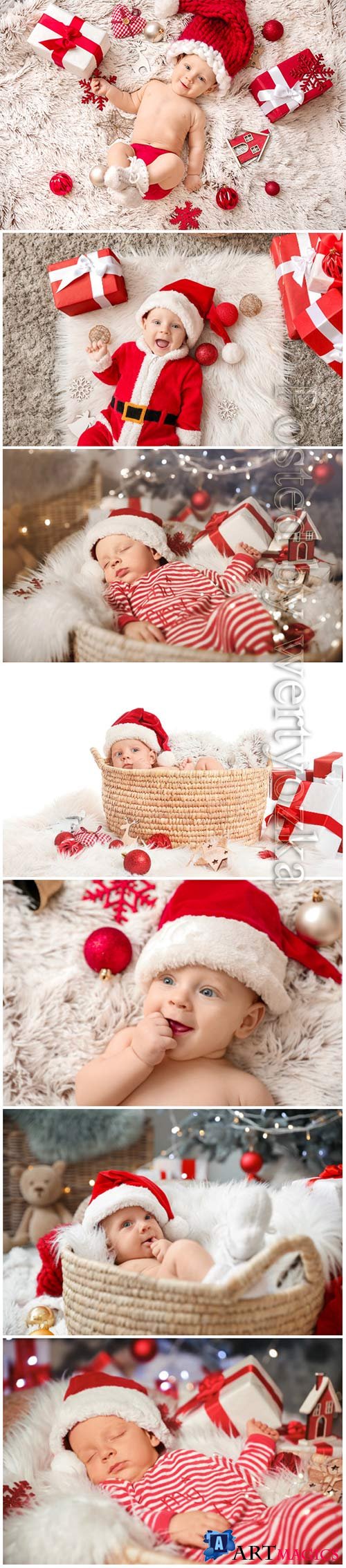 Cute little baby in Santa Claus hat and with Christmas gifts lying on plaid